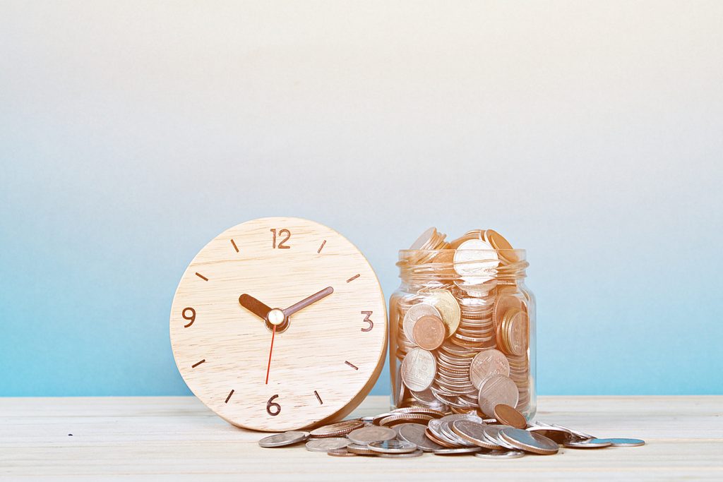 Business, savings time, time is money, deadline or delay concept : wooden alarm clock and coins on white background