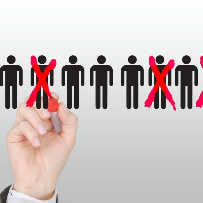 Businessman cutting back job, workforce reduction